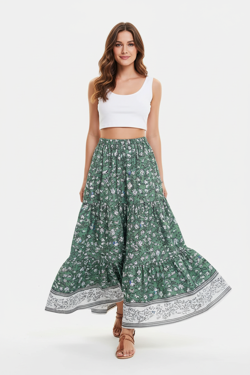 Jupe longue bohème Black-Coat à imprimé floral avec volants étagés et bordure contrastée - mannequin capturée en pleine marche sur fond blanc studio, montrant le mouvement naturel et fluide des volants étagés, la façon dont la jupe ondule avec grâce, l'élégance bohème en mouvement et le tombé parfait du tissu léger