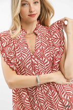 Gros plan détails imprimé feuilles et volants étagés de la robe midi, vue rapprochée du motif feuillage botanique, finitions volants superposés, qualité du tissu fluide, style romantique bohème artisanal
