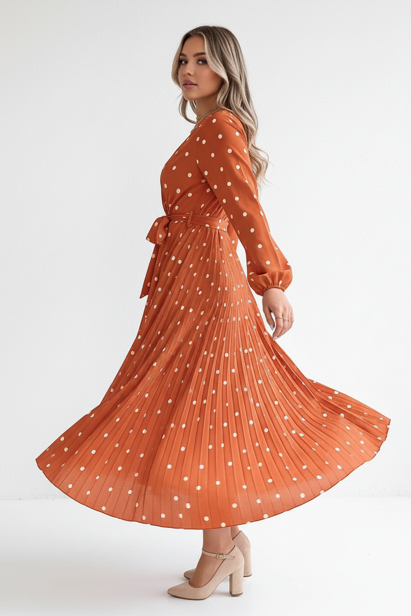 Robe midi à pois terracotta en mouvement - vue latérale capturant le tournoiement de la jupe plissée, illustrant l'amplitude et la fluidité du tissu avec plis permanents - BLACK-COAT