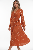 Robe midi à pois terracotta en mouvement - vue latérale capturant le tournoiement de la jupe plissée, illustrant l'amplitude et la fluidité du tissu avec plis permanents - BLACK-COAT