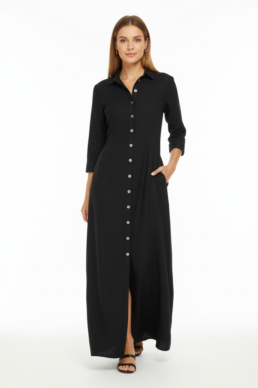 Robe chemise noire longue avec boutonnage frontal et poches latérales - pose en mouvement de face illustrant le confort et l'élégance du vêtement - BLACK-COAT