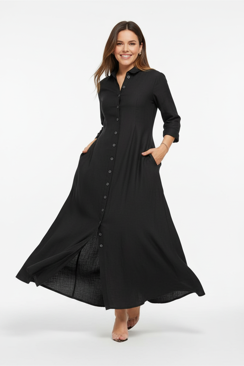 Robe chemise noire longue avec boutonnage frontal et manches trois-quarts - pose dynamique en mouvement révélant la fluidité et l'élégance de la robe chemise - BLACK-COAT