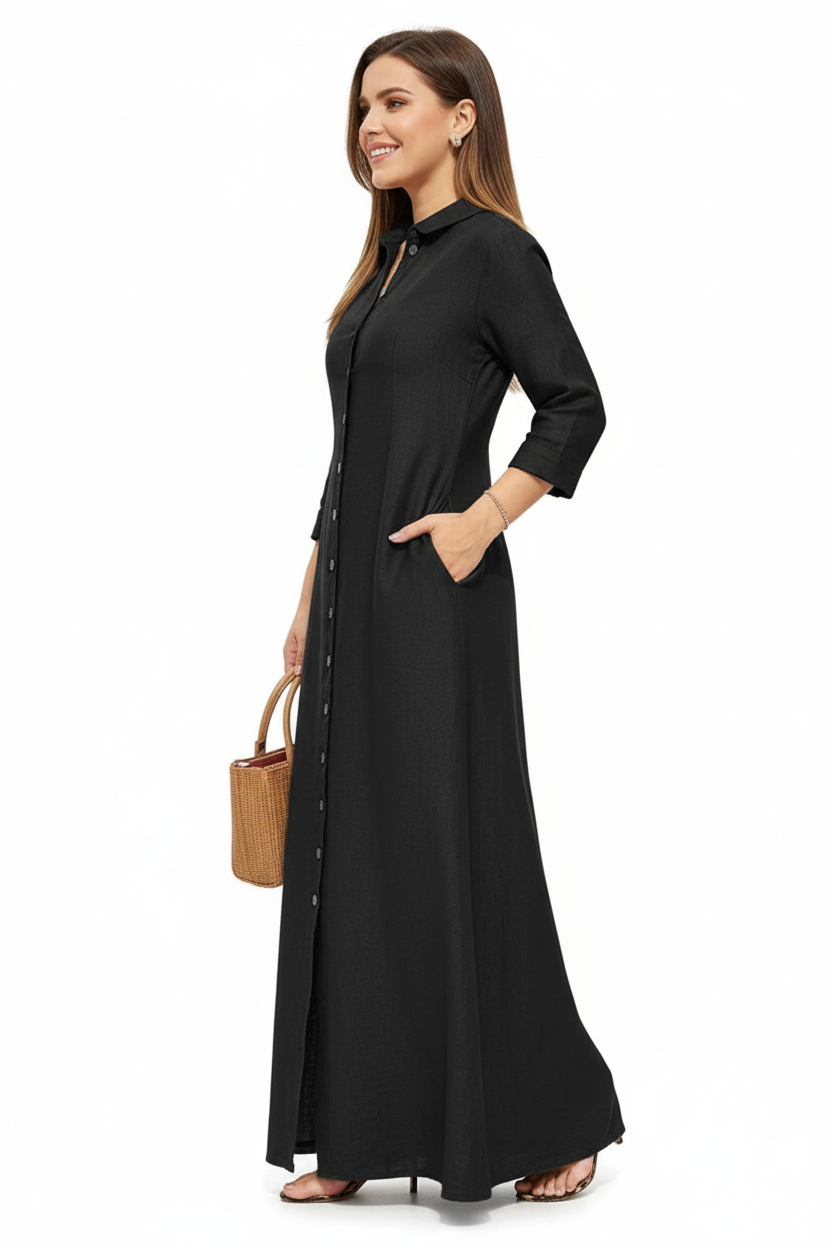 Robe chemise noire longue avec boutonnage frontal, col classique et manches trois-quarts - vue de profil révélant la coupe droite et la longueur maxi - BLACK-COAT